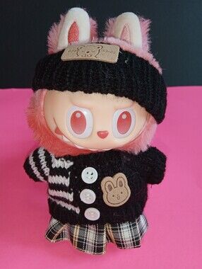 Labibu Doll outfit. Wearing A Knit Striped Sweater, Plaid Skirt, And Headband.